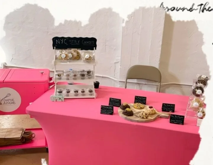 Chapter Azúcar pop-up table dressed in pink with a NYC Style Cookies chalkboard sign