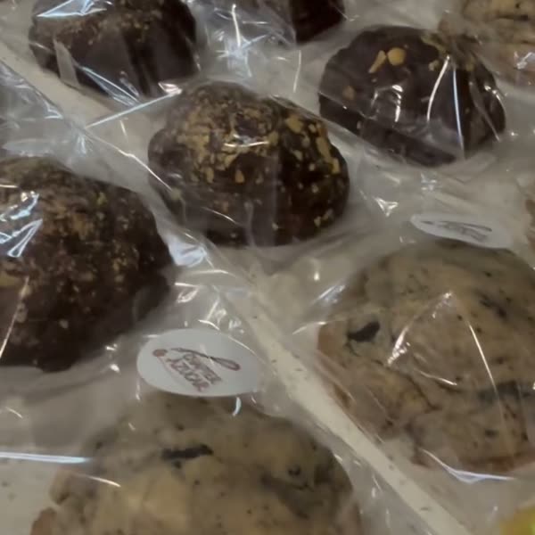Rows of individually wrapped assorted cookies ready to be boxed